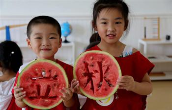 Children eat watermelons to celebrate coming of autumn